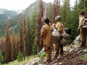 Modern hunter-gatherers wear buckskin clothing on a wilderness survival camping trip.