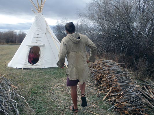 Kenny breaking firewood for the tipi.